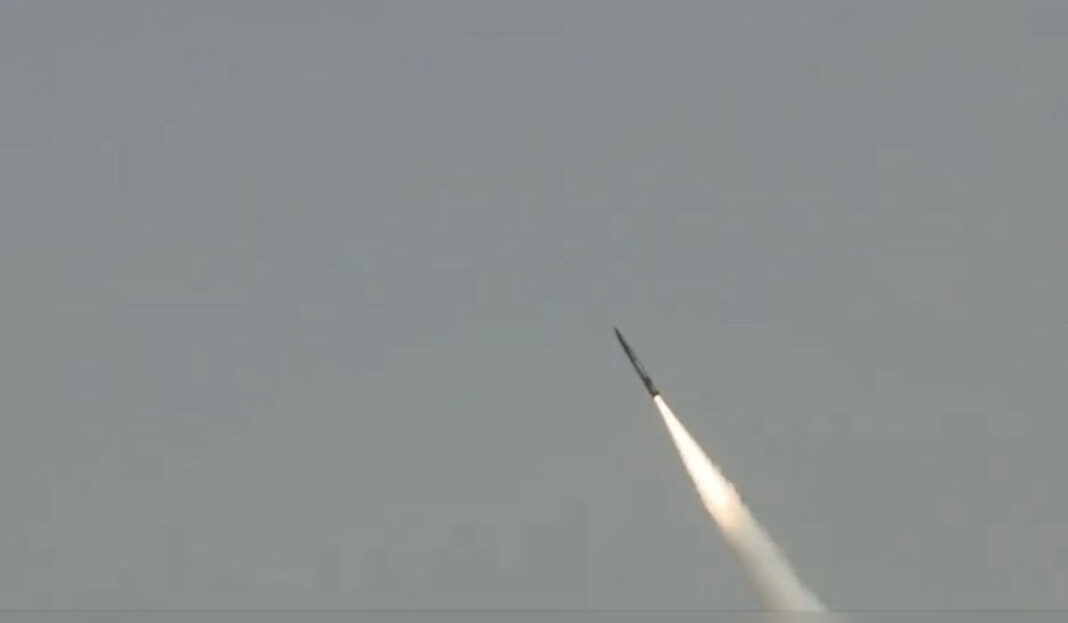Air defence intercepting missiles over Israeli city skyline at night