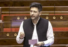 “When Did I Fail?”: Raghav Chadha Challenges AAP After Rajya Sabha Exit Raghav Chadha, Member of Parliament from the Aam Aadmi Party (AAP), standing in the Rajya Sabha (Indian Parliament) while holding a note and addressing the house. He is wearing a white kurta-pyjama with a black Nehru jacket and spectacles.
