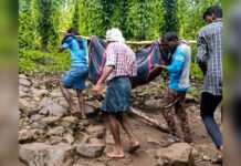 TRIBAL MAHARASHTRA – PART IV Villagers carrying a patient through difficult terrain in a remote tribal region of Maharashtra to access healthcare services.