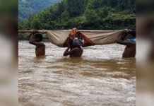 Tribal Maharashtra Part II: Born Beyond the Last Mile? Villagers carrying a patient across a river using a bamboo stretcher in a remote tribal region of Maharashtra.