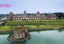 Beyond Heritage: How Madhya Pradesh is Turning Monsoon Tourism into an Economic Opportunity Jahaz Mahal in Mandu surrounded by lush greenery during the monsoon season in Madhya Pradesh.