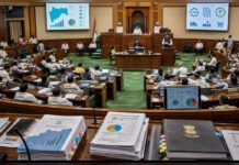 Maharashtra GST Amendment Bill 2026 Introduced in Assembly to Align State Law with GST Council Decisions Maharashtra Legislative Assembly in session as the Maharashtra GST (Amendment) Bill, 2026 is introduced, with lawmakers, legislative documents, GST-related presentations and budget papers visible inside the Assembly chamber.