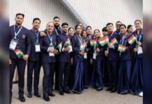 Beyond Weightlifting: India’s Glasgow Rise Members of the Indian contingent at the Glasgow 2026 Commonwealth Games pose with the national flag outside the competition venues.