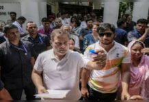 Delhi Police Registers FIR Over Pellet Gun Injury After Rahul Gandhi’s Dharna With Student Rahul Gandhi sits with Sahil Lochab during protest outside Delhi Police station over alleged pellet gun injury