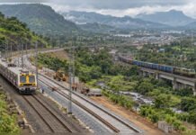 ₹497-Crore Chouk-Karjat Doubling Adds Another Layer to the Panvel-Karjat Rail Capacity Build-Out Editorial illustration showing railway track doubling, a suburban train and freight movement through the Western Ghats near the Panvel-Karjat corridor.